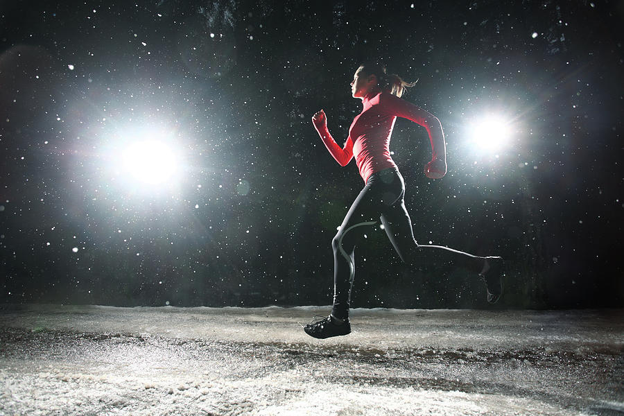Woman Running At Night In Snow by Stanislaw Pytel